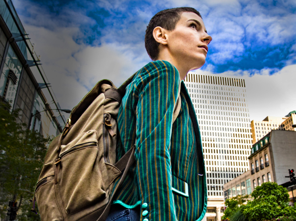 A woman with a rucksack on looking upwards